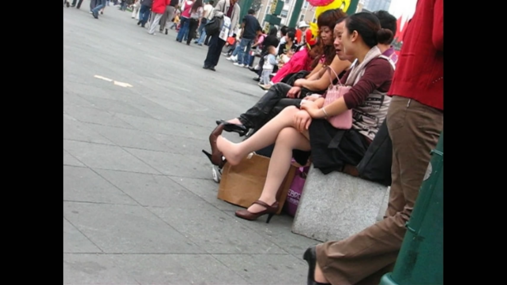 Women's shoes brown heels sitting with legs dangling